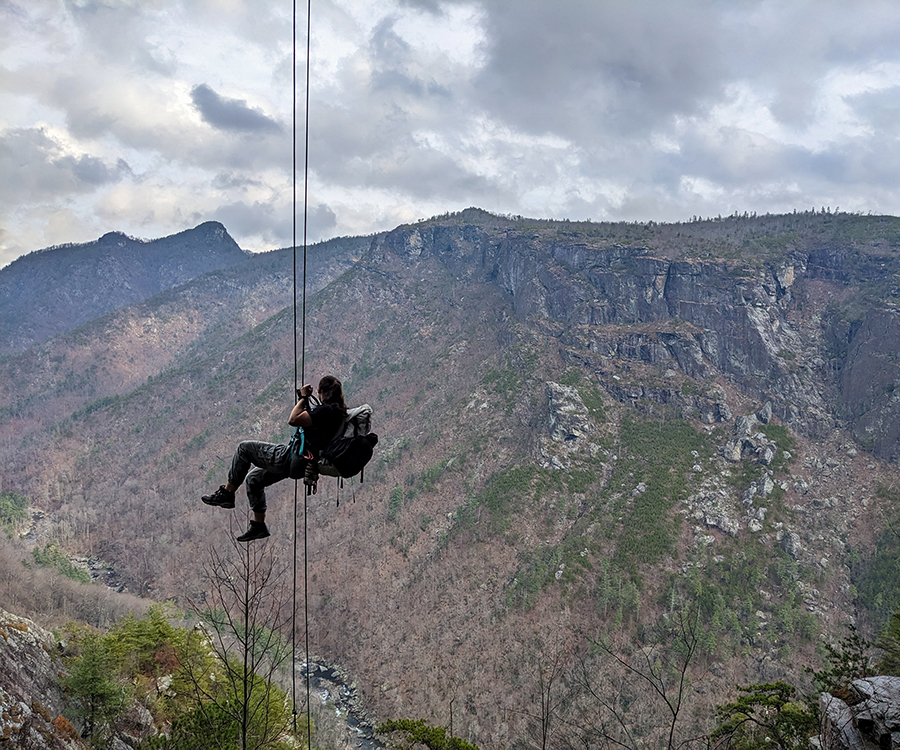 Climber rappelling an overhang in Linville Gorge