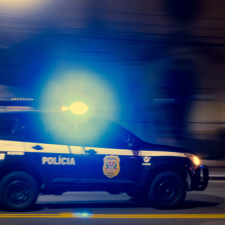 police car driving at night with emergency lights on